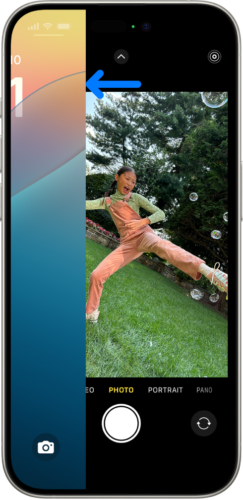 The iPhone screen showing the Lock Screen sliding to the left and the Camera open on the right side of the screen.