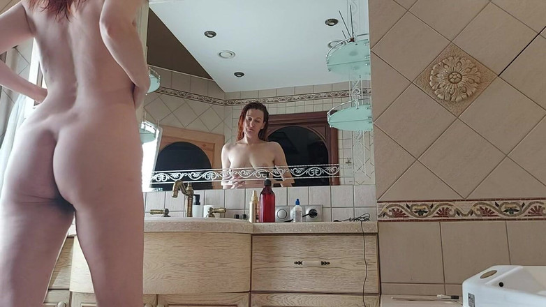 GinnaGg: A Charming Woman Is Preening in the Bathroom in Front...
