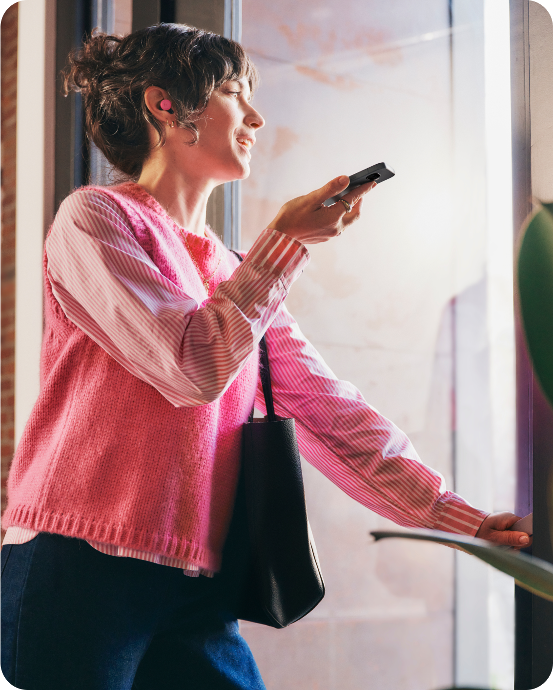 A woman using her Google Pixel 9a phone.