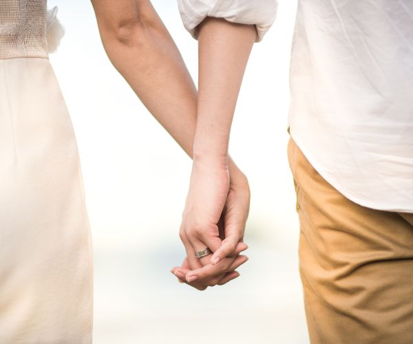man and woman holding hands