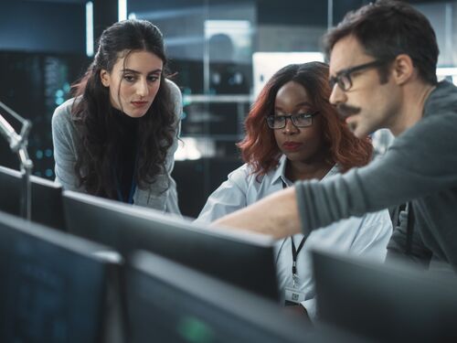 Group of Empowered Multicultural Specialists Working in a Research Center, Using Computer to Collaborate on Advanced Software, Develop Artificial Intelligence Interface and Cloud-Based Blockchain