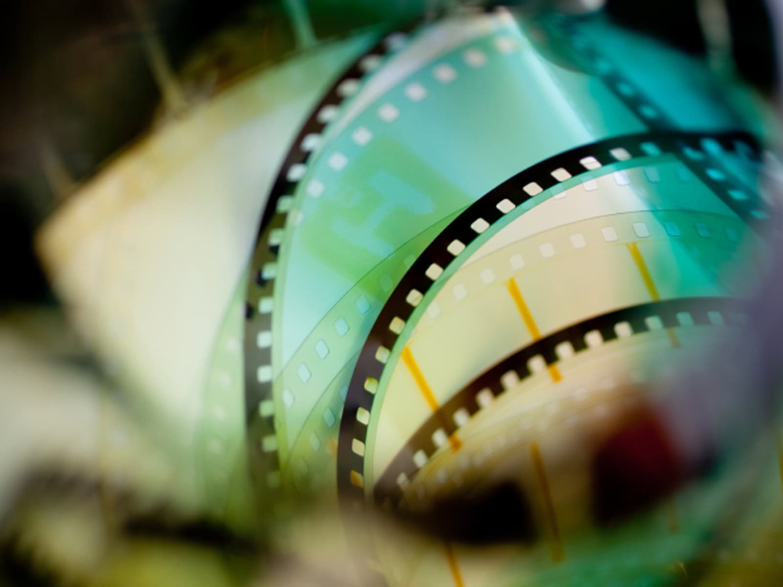 A close-up of a film strip against a green background.